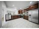 Spacious kitchen with stainless steel appliances, dark cabinets, and tiled flooring, perfect for cooking at 523 Eastern Isle Ave, Summerville, SC 29486