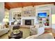 Cozy living room with a stone fireplace, built-in bookshelves, and comfortable armchairs at 523 Eastern Isle Ave, Summerville, SC 29486