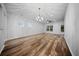 Bright living room showcasing hardwood floors, modern lighting, and large windows at 523 Eastern Isle Ave, Summerville, SC 29486