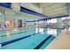 Indoor swimming pool with blue tiled trim, marked lanes, and ample natural light at 523 Eastern Isle Ave, Summerville, SC 29486