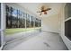 A screened-in porch features a ceiling fan and a view of the forest at 523 Eastern Isle Ave, Summerville, SC 29486