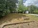 Spacious back yard with garden beds, outbuildings and lots of mature trees, perfect for gardening and outdoor activities at 5273 Potomac St, North Charleston, SC 29405