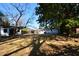 Large backyard showcasing a white house, shed, and ample green space, perfect for outdoor activities and relaxation at 5273 Potomac St, North Charleston, SC 29405