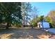 Spacious backyard featuring mature trees, a white shed with basketball hoop, and a well-maintained lawn at 5273 Potomac St, North Charleston, SC 29405