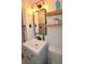 Cozy bathroom featuring a white vanity, wooden shelves, and modern lighting, creating a serene and inviting atmosphere at 5273 Potomac St, North Charleston, SC 29405