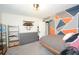 Modern bedroom featuring a platform bed, dresser, and geometric wall design, creating a stylish and functional space at 5273 Potomac St, North Charleston, SC 29405
