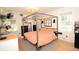 Bright bedroom features a four-post bed frame, built-in storage with a wood counter and a large window for natural light at 5273 Potomac St, North Charleston, SC 29405