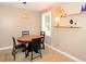 Cozy dining area with round wooden table, floating shelves, and a window providing ample sunlight at 5273 Potomac St, North Charleston, SC 29405