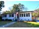 Charming white brick home with black shutters, American flag, and well-manicured lawn at 5273 Potomac St, North Charleston, SC 29405
