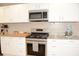 Bright kitchen features white cabinets, granite countertops, and stainless steel appliances at 5273 Potomac St, North Charleston, SC 29405