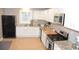 Modern kitchen features white cabinets, stainless steel appliances, and a tile floor at 5273 Potomac St, North Charleston, SC 29405