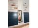 A custom built-in shelving unit features shelving, drawers, wood counters, and a mirror for decor at 5273 Potomac St, North Charleston, SC 29405