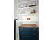 Close up of shelving with wood counter featuring various items for decor and storage at 5273 Potomac St, North Charleston, SC 29405