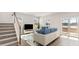 Bright living room with a comfortable sofa, stairs, large windows, and sliding glass doors to a lake view at 550 Richfield Way, Summerville, SC 29486