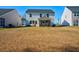 Expansive backyard view with a white home with a screened-in porch at 573 Yellow Leaf Ln, Summerville, SC 29486