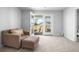 Bright bedroom with a comfortable chair and ottoman near the door to the outside balcony at 573 Yellow Leaf Ln, Summerville, SC 29486