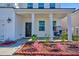 Welcoming front porch with a chair and a cozy seating area, complemented by beautiful plants at 573 Yellow Leaf Ln, Summerville, SC 29486
