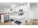 This kitchen has stainless appliances, bright lighting, white cabinets, and wood-look flooring at 573 Yellow Leaf Ln, Summerville, SC 29486