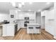Bright white kitchen features a center island with seating and stainless steel appliances at 573 Yellow Leaf Ln, Summerville, SC 29486