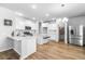 A modern white kitchen featuring stainless appliances, an island, and quartz countertops at 573 Yellow Leaf Ln, Summerville, SC 29486