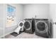 Well-equipped laundry room with modern washer, dryer, and ample space at 573 Yellow Leaf Ln, Summerville, SC 29486