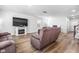 Spacious living room featuring a fireplace, large TV, and light wood-look floors at 573 Yellow Leaf Ln, Summerville, SC 29486