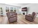 Bright living room with fireplace, large TV, and comfortable seating with natural light at 573 Yellow Leaf Ln, Summerville, SC 29486