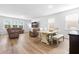 Open-concept living space with hardwood floors, comfortable seating, and a dining area at 573 Yellow Leaf Ln, Summerville, SC 29486
