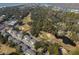 Comprehensive aerial view featuring residential areas, a golf course, and waterway at 601 Magnolia Ln, Edisto Island, SC 29438