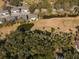 A beautiful aerial view showcases the townhouse's idyllic setting amongst trees and ponds at 601 Magnolia Ln, Edisto Island, SC 29438
