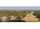 Aerial view of golf course and several homes amidst many trees and a small pond at 601 Magnolia Ln, Edisto Island, SC 29438