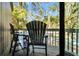 Private balcony with outdoor seating, providing a tranquil view of surrounding trees and scenery at 601 Magnolia Ln, Edisto Island, SC 29438