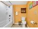 Bright bathroom features a shower-tub combo, toilet, and decorative shelving, creating a functional space at 601 Magnolia Ln, Edisto Island, SC 29438