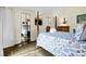 Comfortable bedroom features a mirrored closet, hardwood floors, and neutral colors for a relaxing atmosphere at 601 Magnolia Ln, Edisto Island, SC 29438