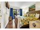 Bright bedroom with a king bed, a coastal theme, and a private balcony overlooking trees at 601 Magnolia Ln, Edisto Island, SC 29438