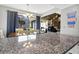 Open dining area with modern lighting, views of a spiral staircase, and access to an outdoor balcony at 601 Magnolia Ln, Edisto Island, SC 29438