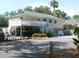 Charming coastal community home with a white picket fence, deck, and lush landscaping at 601 Magnolia Ln, Edisto Island, SC 29438