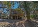 Charming raised beach house with wooden deck and shaded parking beneath the home at 601 Magnolia Ln, Edisto Island, SC 29438