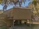 Charming elevated coastal home featuring a spacious deck and covered parking, perfect for outdoor living at 601 Magnolia Ln, Edisto Island, SC 29438