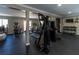 Well-equipped home gym with various exercise machines, weights, and a TV at 601 Magnolia Ln, Edisto Island, SC 29438