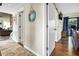 Hallway with wood flooring, a beachy decor, and access to multiple rooms and a back deck at 601 Magnolia Ln, Edisto Island, SC 29438
