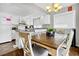 Inviting kitchen with white cabinets, modern appliances, a breakfast bar, and an adjacent dining area at 601 Magnolia Ln, Edisto Island, SC 29438