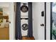 Convenient laundry closet with a stacked washer and dryer, neatly concealed by curtains for a clean look at 601 Magnolia Ln, Edisto Island, SC 29438