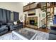 Comfortable living room with a stone fireplace, spiral staircase, and an open floor plan at 601 Magnolia Ln, Edisto Island, SC 29438