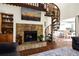 Cozy living room with stone fireplace, TV, spiral staircase, and open access to the kitchen at 601 Magnolia Ln, Edisto Island, SC 29438