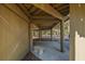 Covered area underneath the elevated home, providing sheltered space and a stone bench at 601 Magnolia Ln, Edisto Island, SC 29438