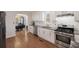 A stylish kitchen featuring white cabinets, stainless steel appliances, and granite countertops at 680 Kent St, Mount Pleasant, SC 29464