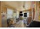 Cozy living room featuring wood paneling, a ceiling fan, natural light, and an entertainment center at 680 Kent St, Mount Pleasant, SC 29464