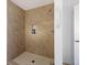 Modern shower featuring decorative tile surround, built-in niche, and a convenient grab bar at 680 Kent St, Mount Pleasant, SC 29464