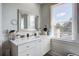 Bright bathroom featuring a large white vanity, mirror, shiplap walls, and a window for natural light at 757 King St, Charleston, SC 29403